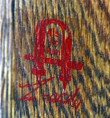 Close up Gustav Stickley signature red decal used circa 1905-1912.